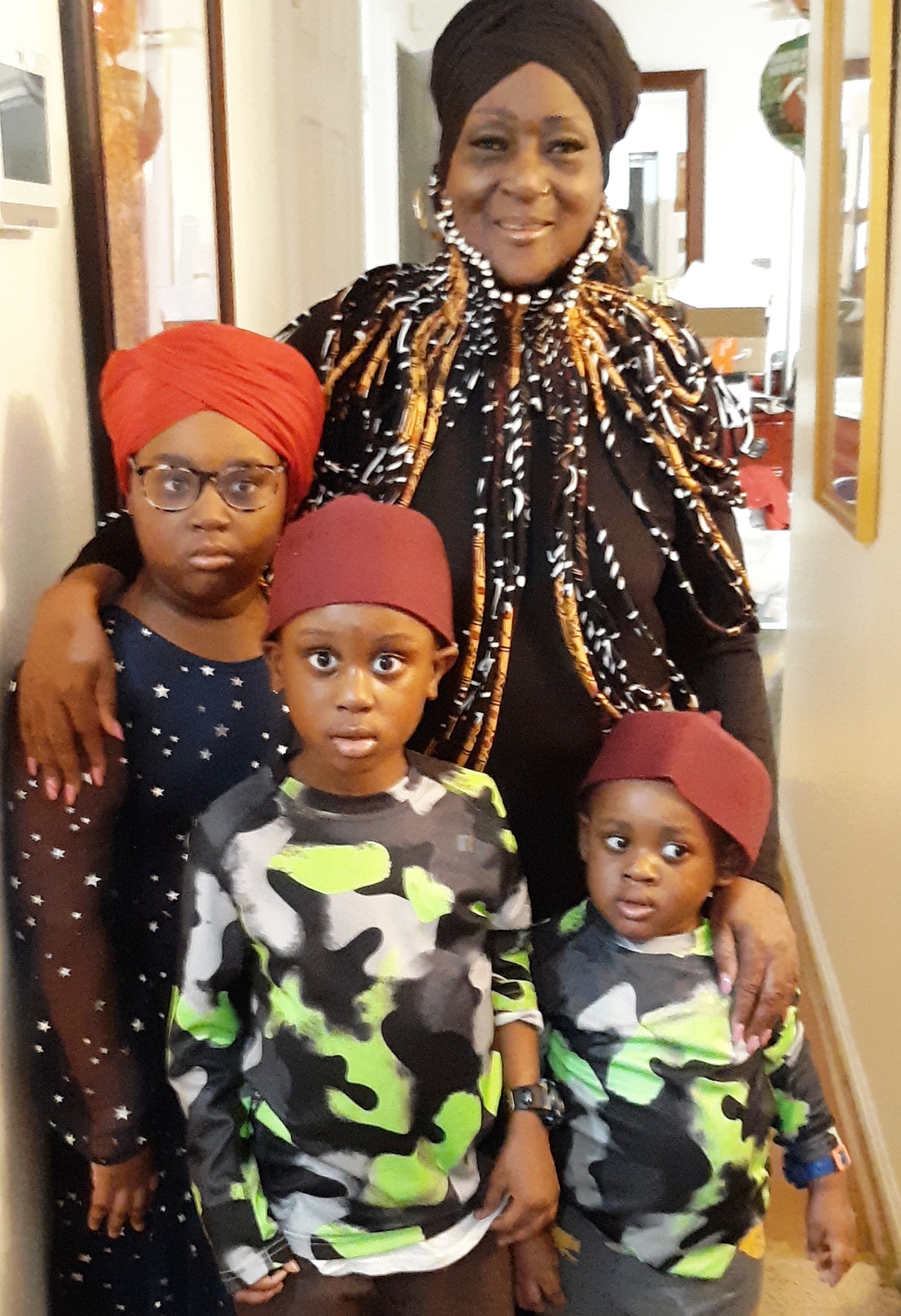 Prime Minister Durriyyah Bey standing with her grandchildren