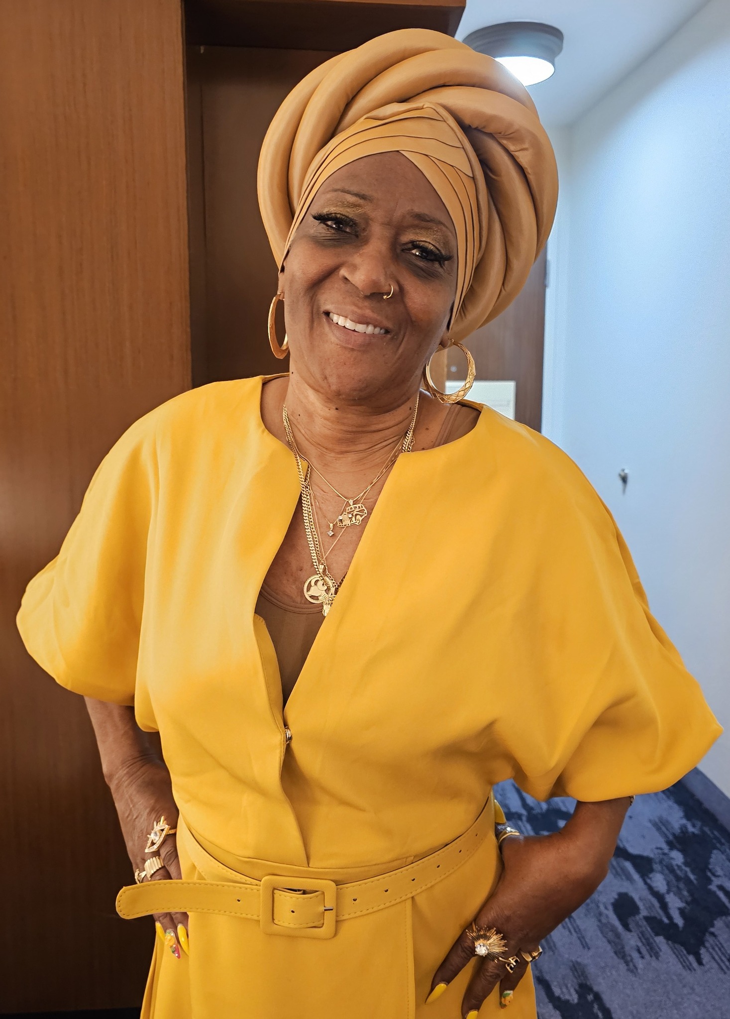 Prime Minister NGSKS Durriyyah Bey wearing mustard-colored attire and a matching turban